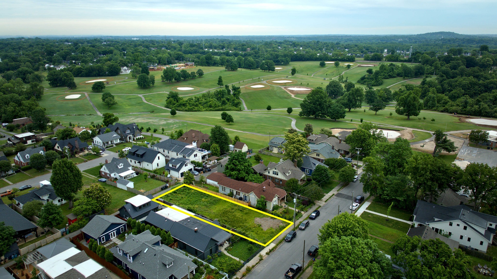 an aerial view of multiple houses with yard