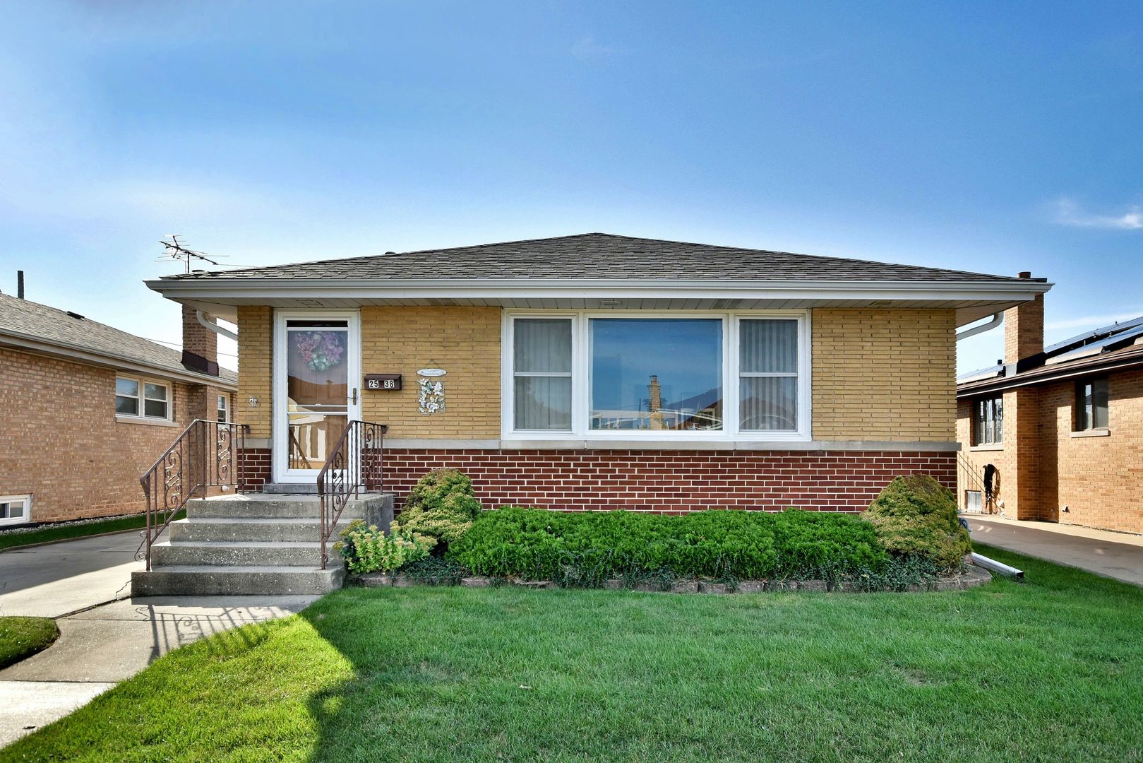 a front view of a house with a garden