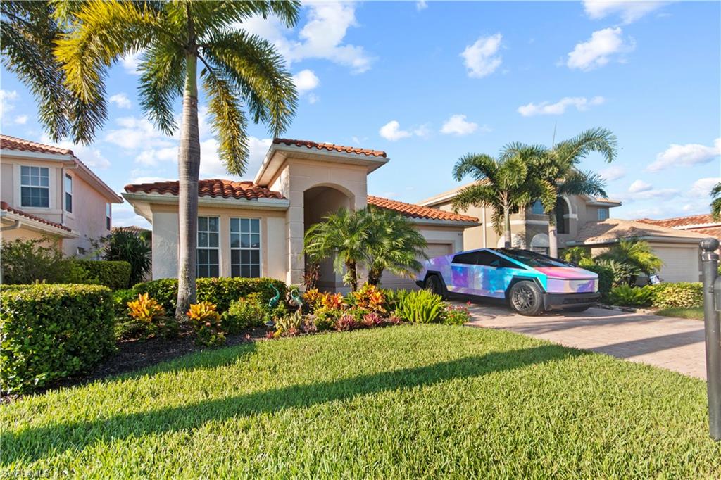 a view of a house with a big yard and potted plants