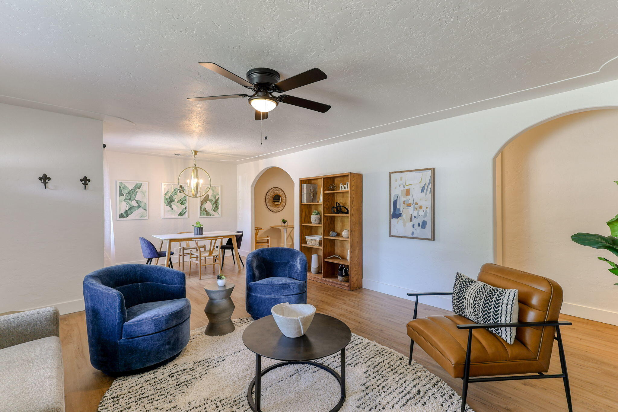 a living room with furniture ceiling fan and a rug