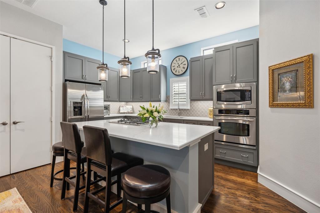 a kitchen with stainless steel appliances a stove a sink and a refrigerator