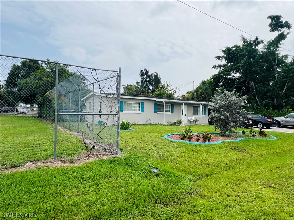 a view of a house with backyard and swimming pool