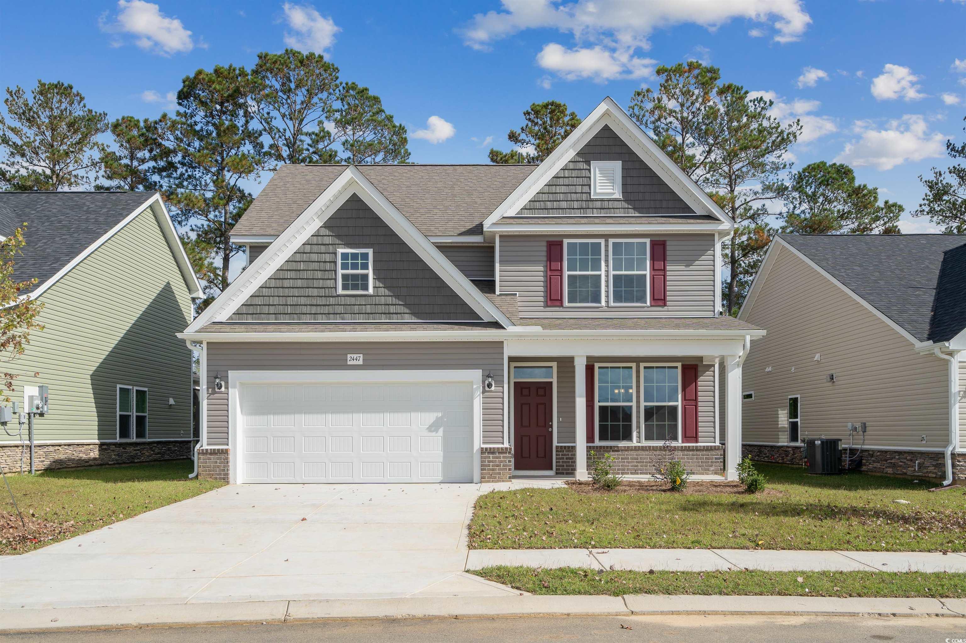 Craftsman-style house with cooling unit, a front y