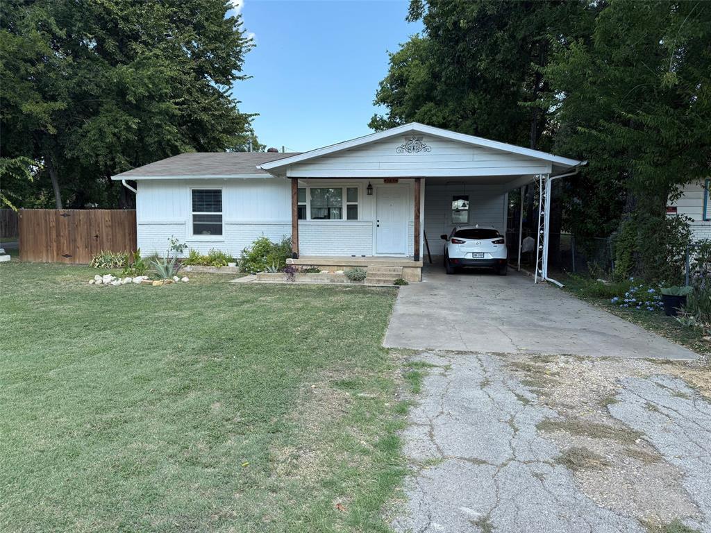 a front view of a house with a yard and trees