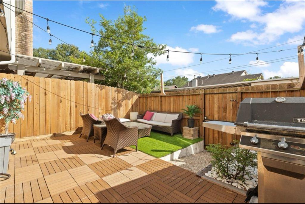 a view of a patio with couches table and chairs and potted plants