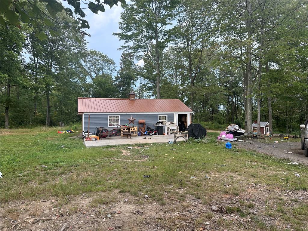 a view of a house with backyard porch and sitting area