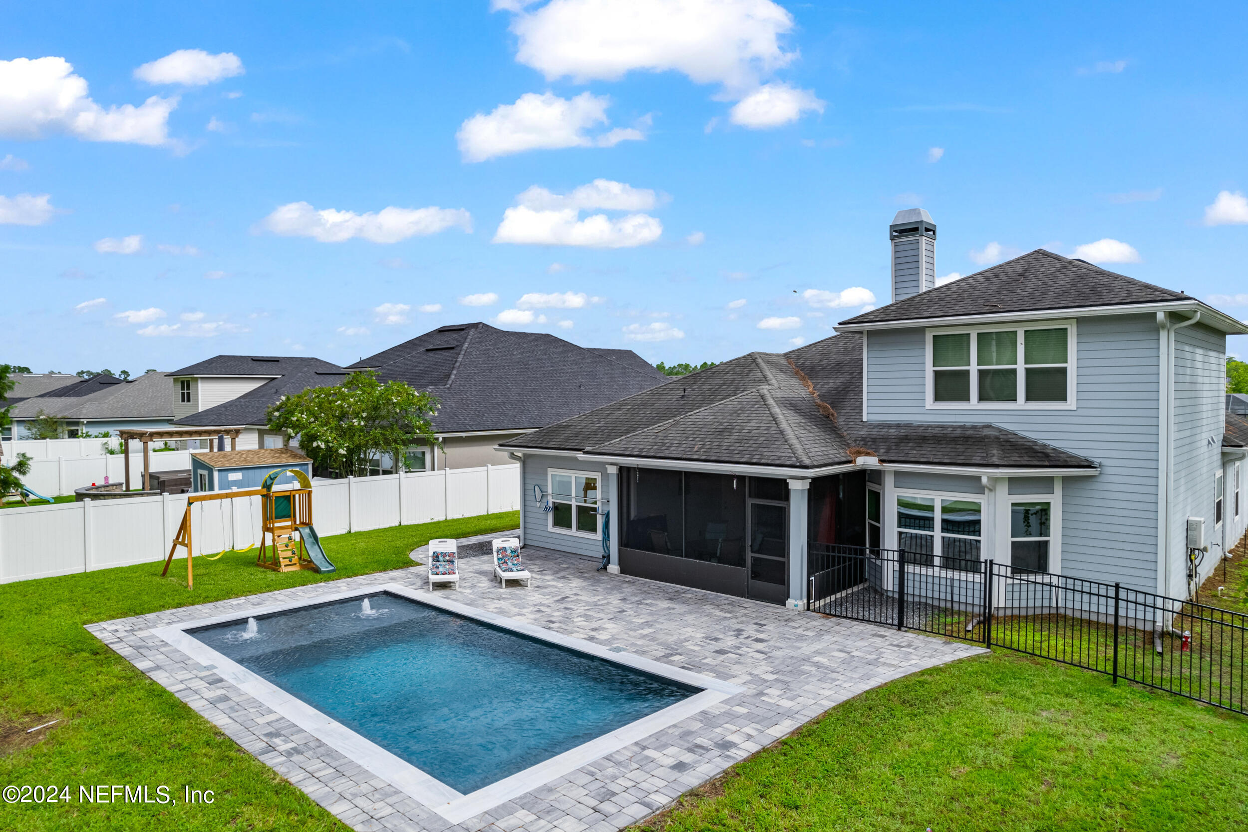 a view of a house with a yard and sitting area