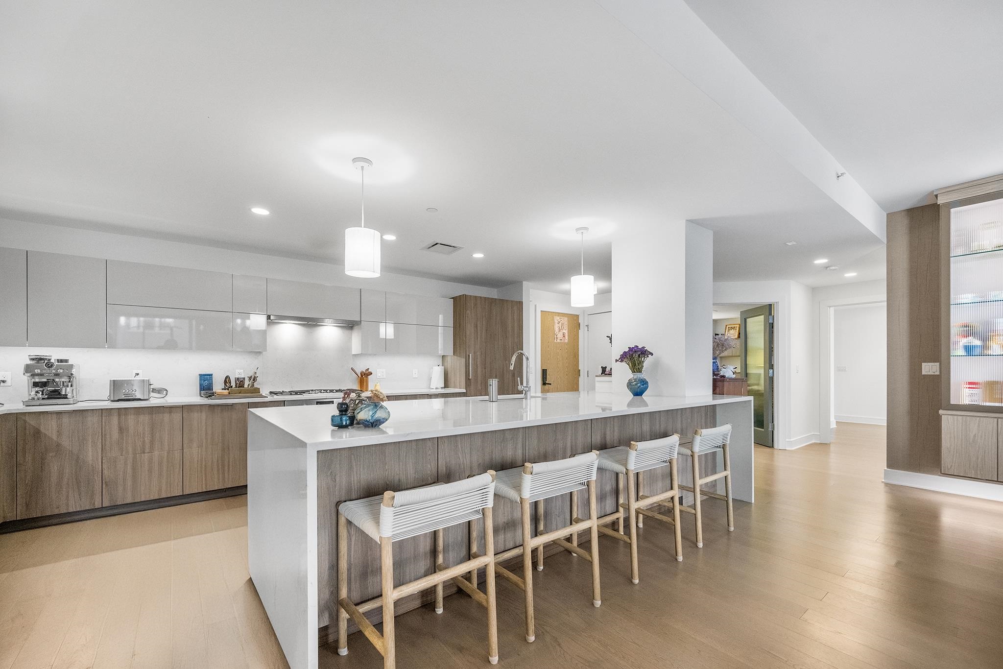 a large kitchen with lots of counter space and dining table chairs