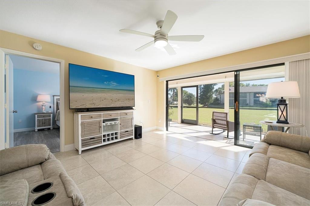 Living room featuring ceiling fan and light tile patterned flooring