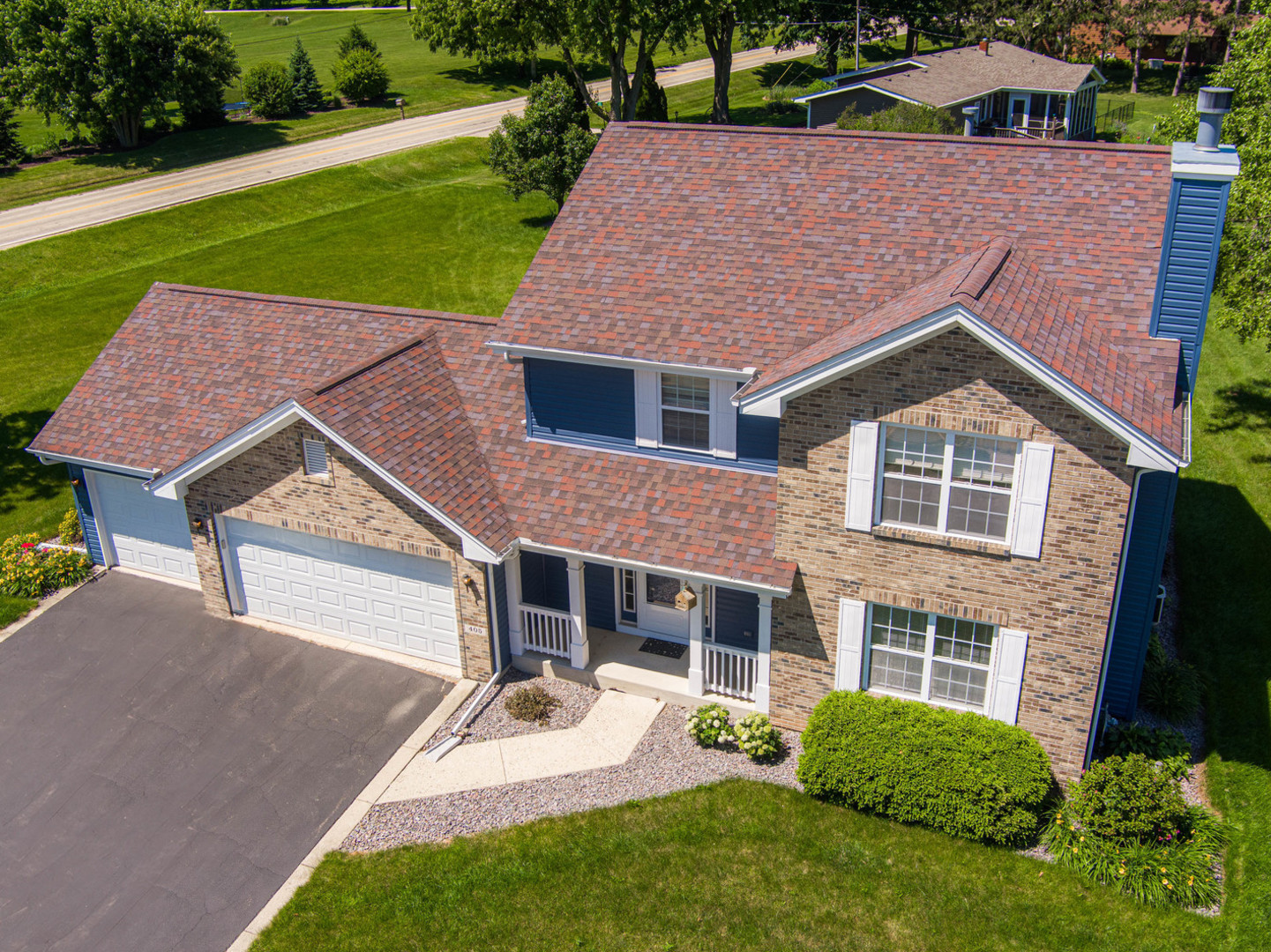 a aerial view of a house next to a yard