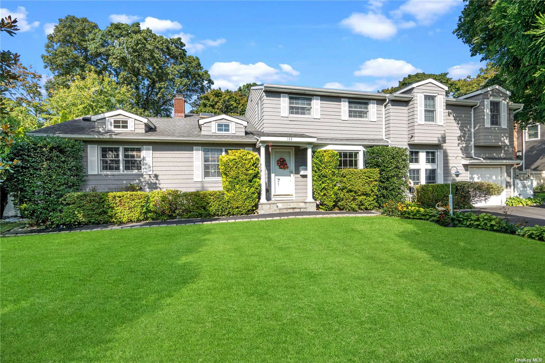 a front view of house with yard and green space