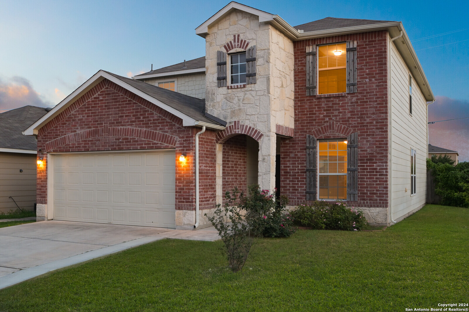 a front view of a house with a yard and garage