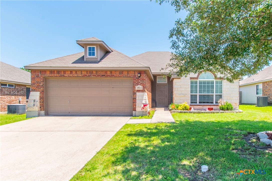 a front view of a house with a yard and garage