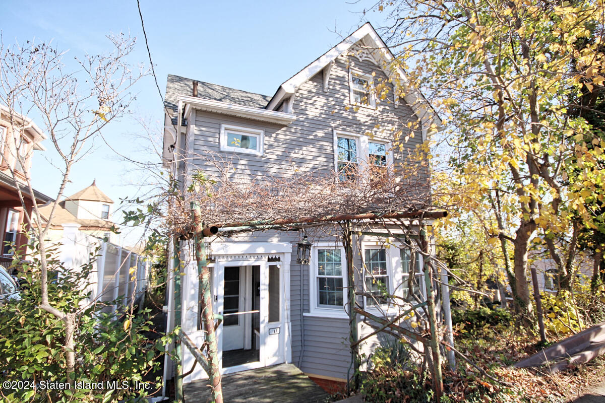 front view of a house with a tree