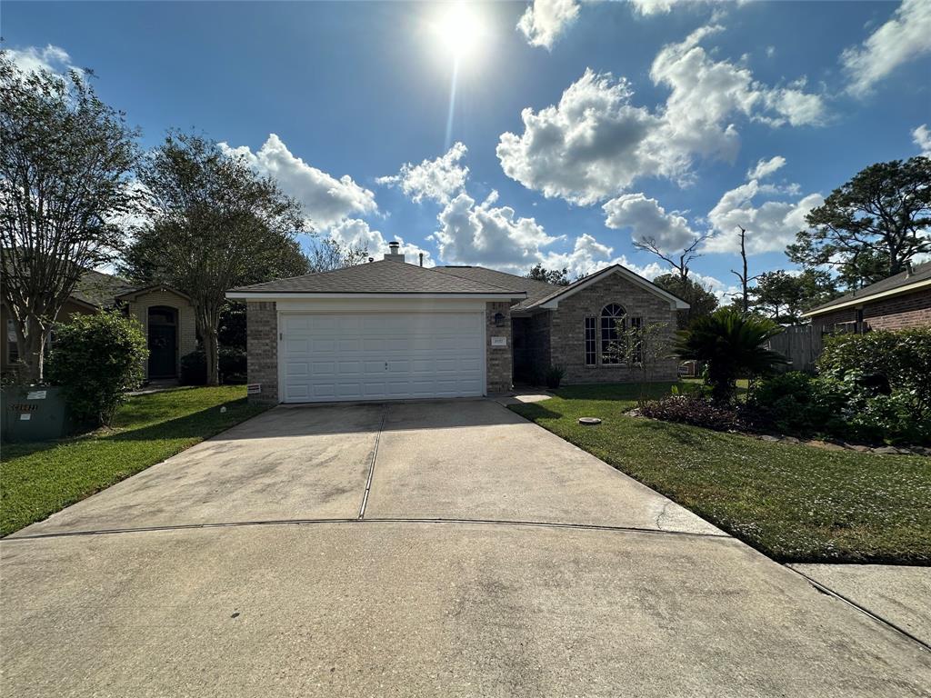 a front view of a house with a yard and a garage