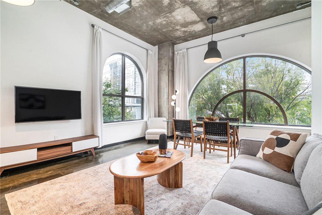 a living room with furniture fireplace and flat screen tv