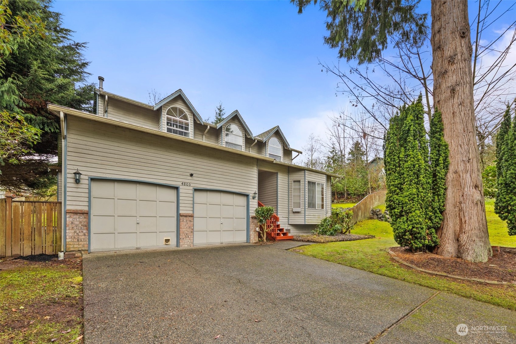 a view of a house with a yard and garage