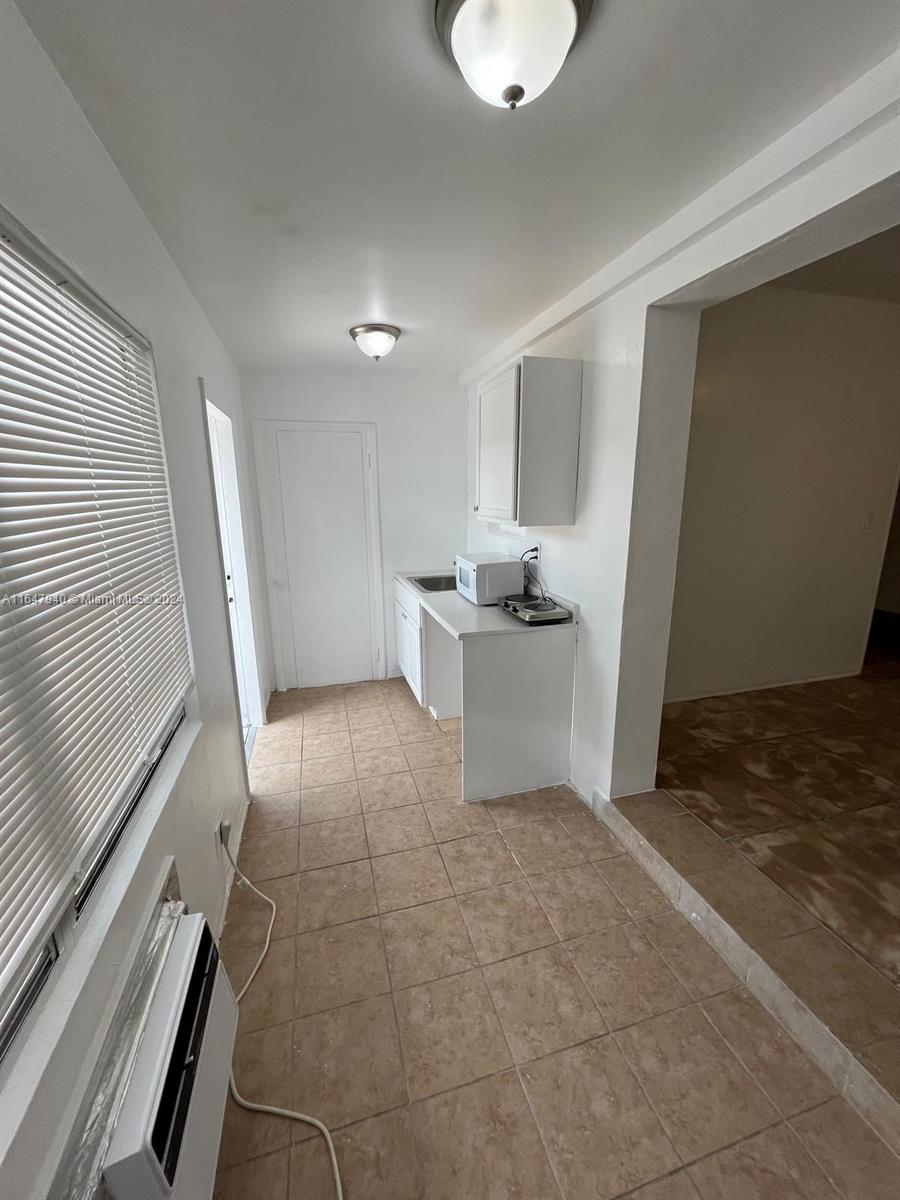 a view of a kitchen with a sink cabinets and a window