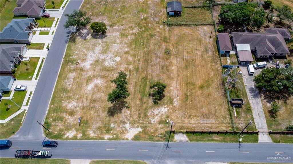 an aerial view of residential house with outdoor space and trees