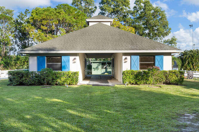 a front view of house with yard and green space