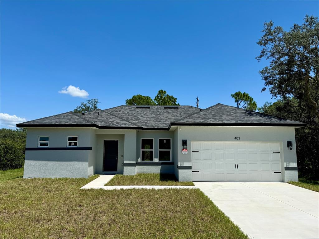 a front view of a house with a yard