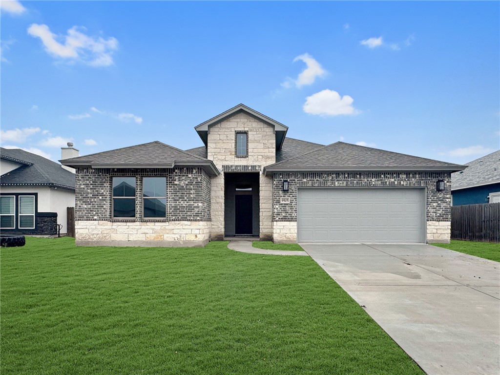 a front view of a house with a yard and garage