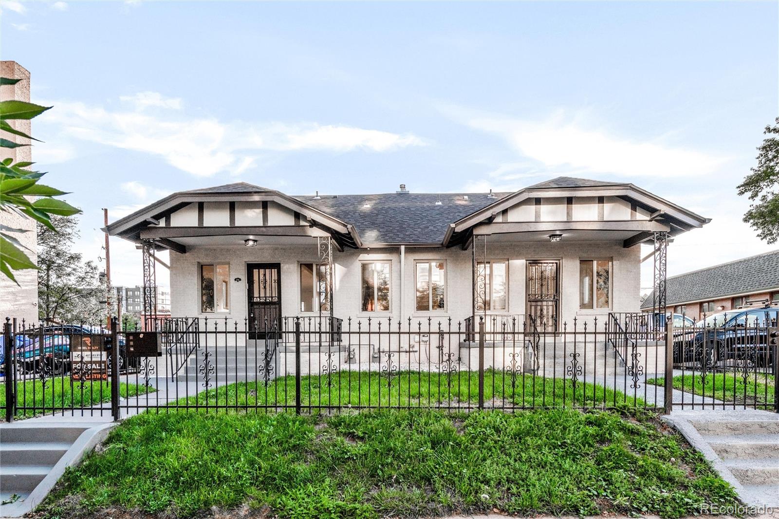 a view of a brick house with a wooden fence