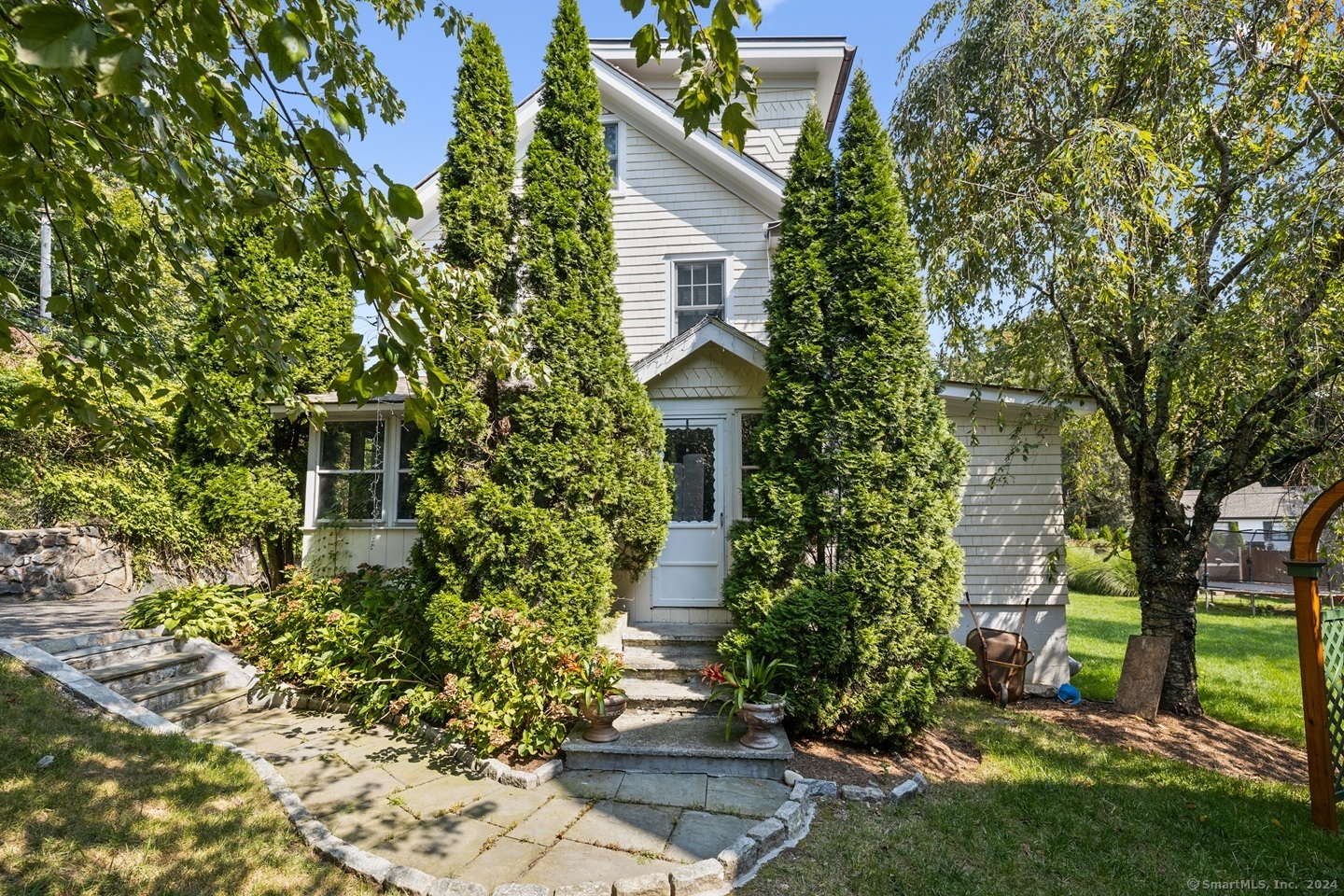 a front view of a house with garden