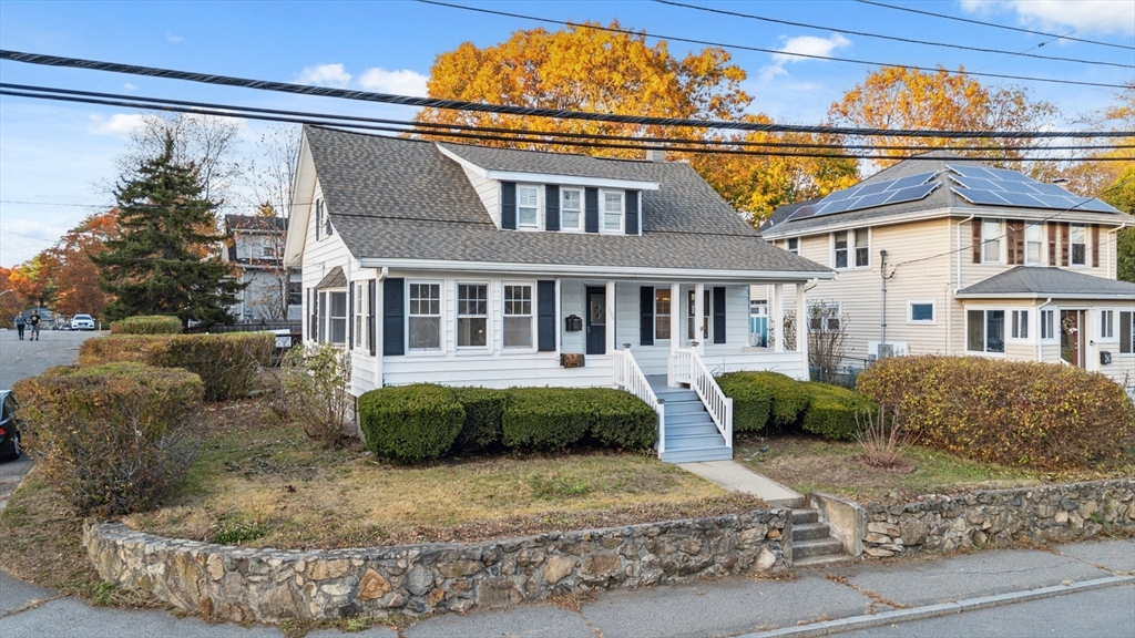 a front view of a house with a garden