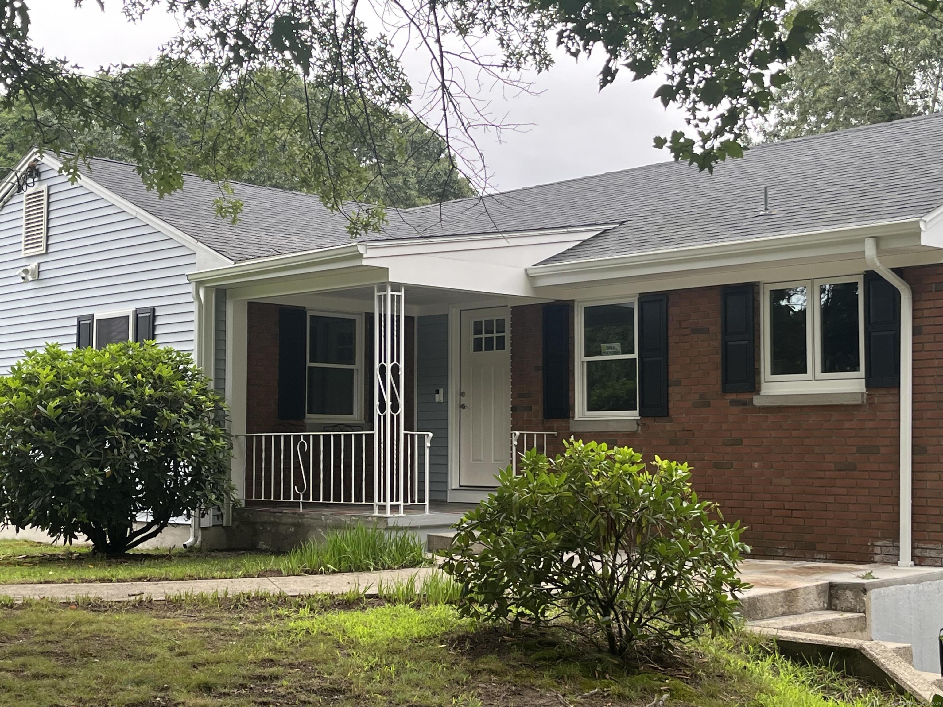 a front view of a house with a garden