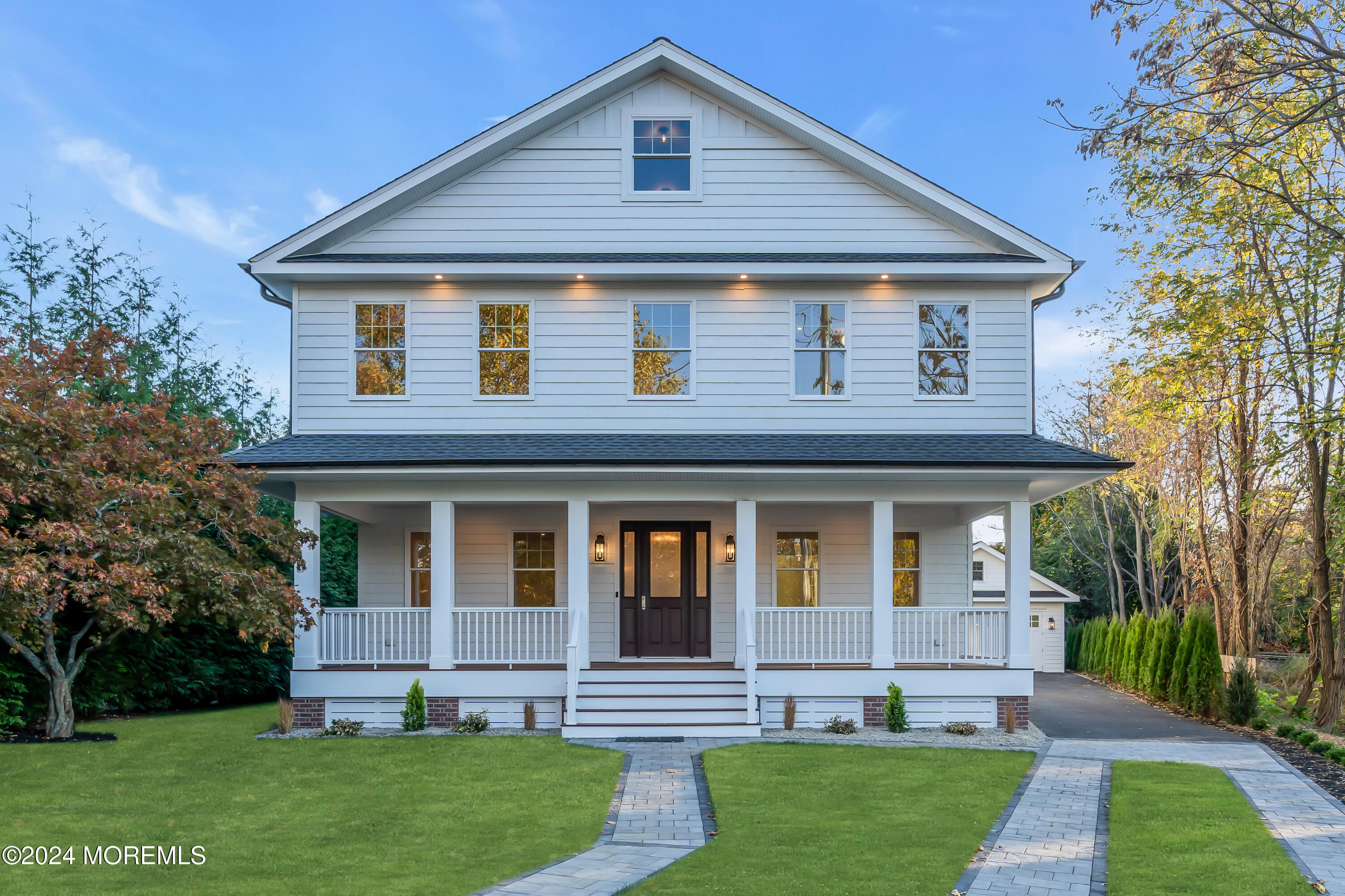 a front view of a house with a garden