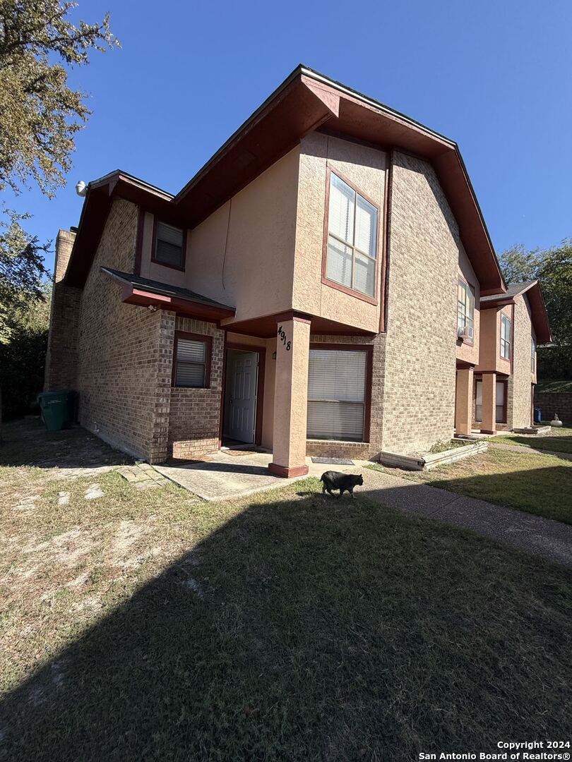 a front view of a house with a yard