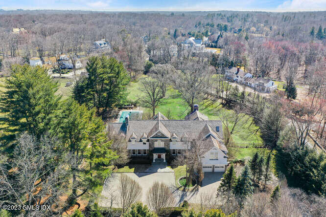 a aerial view of a house with a yard and large tree