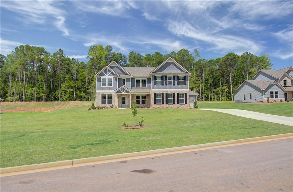 a front view of a house with a garden