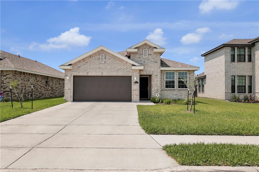 View of front facade with a front yard and a garage