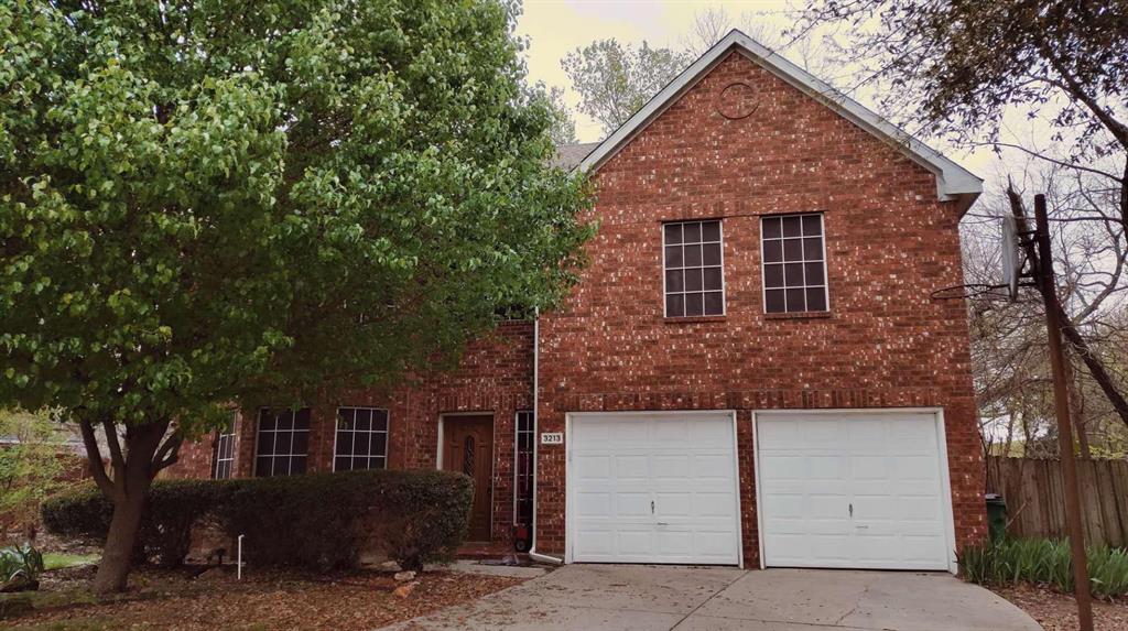 front view of a house with a tree