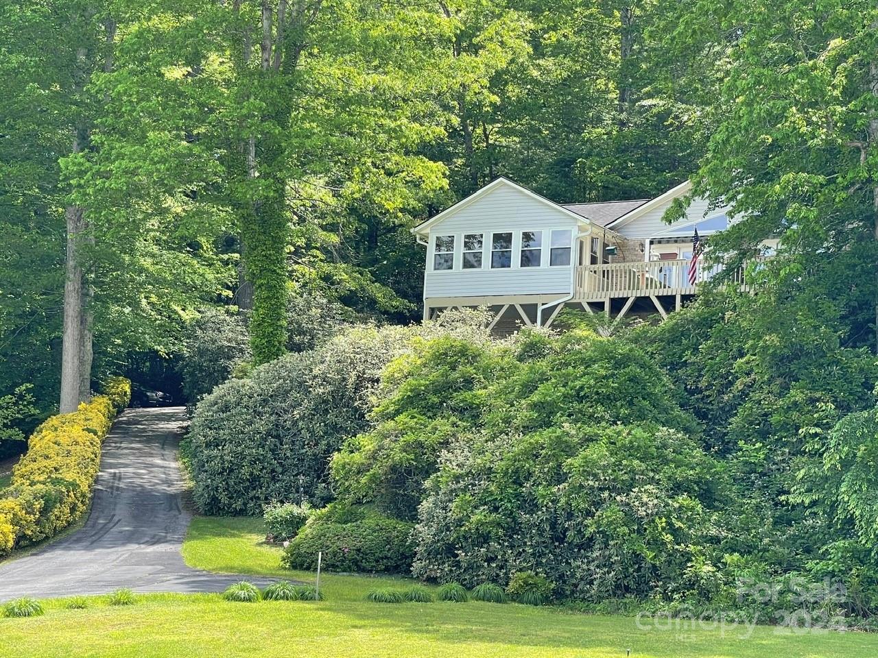 a view of a house with swimming pool and garden