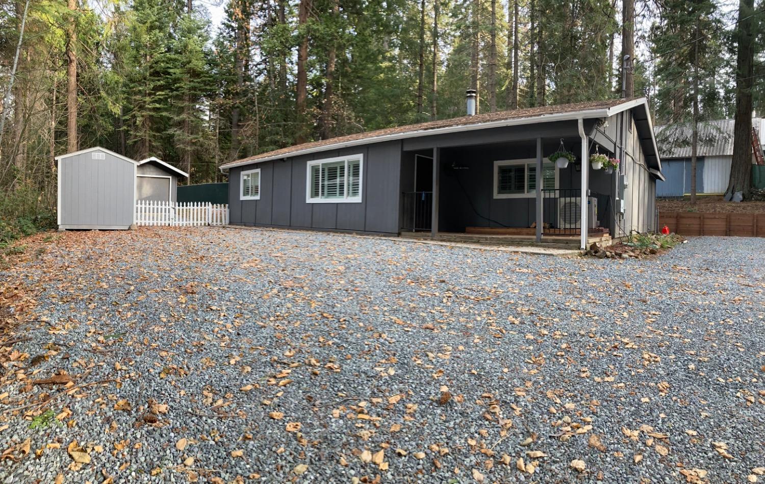 a front view of a house with a garden and yard