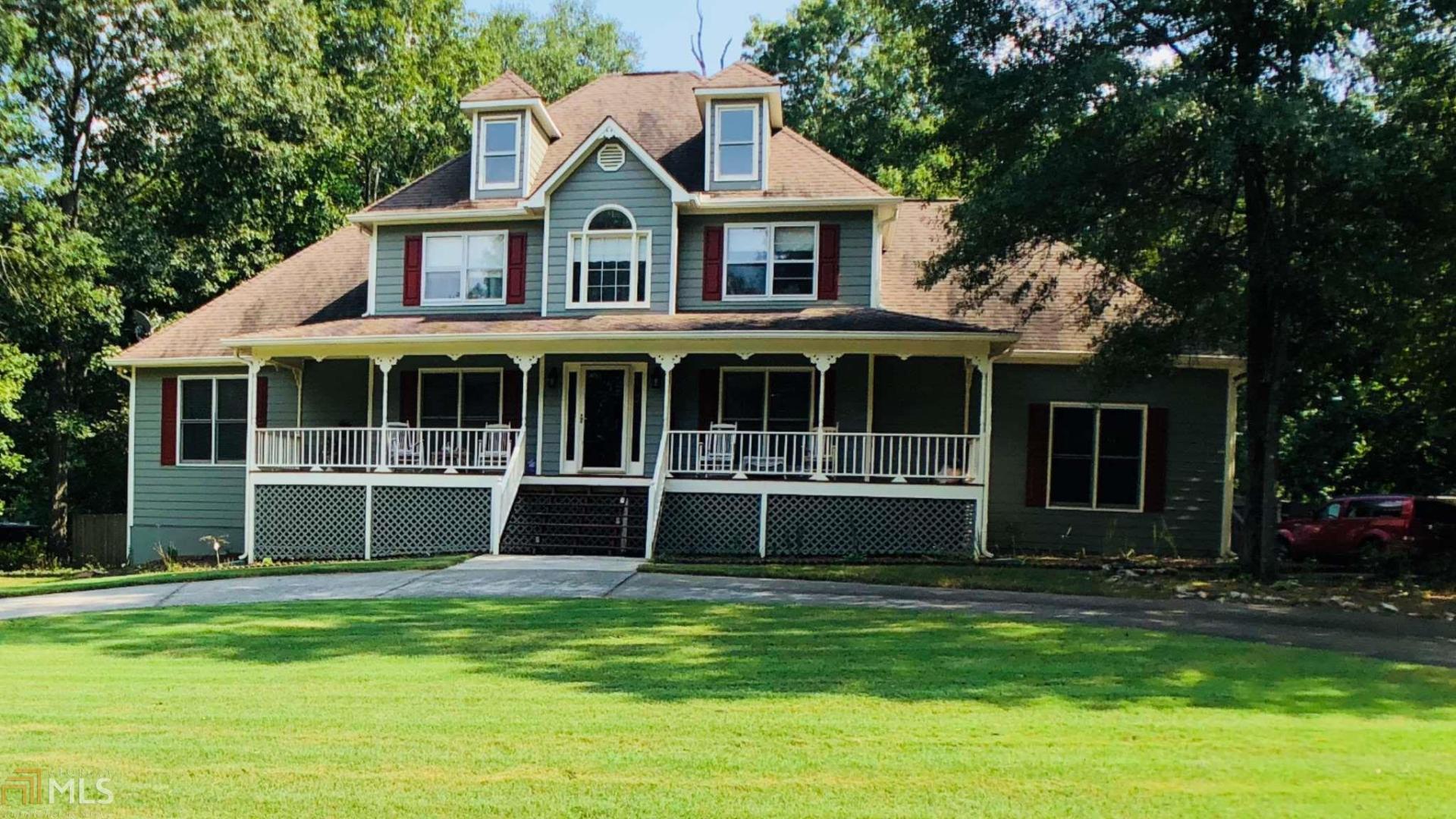 a house with a big yard and large trees