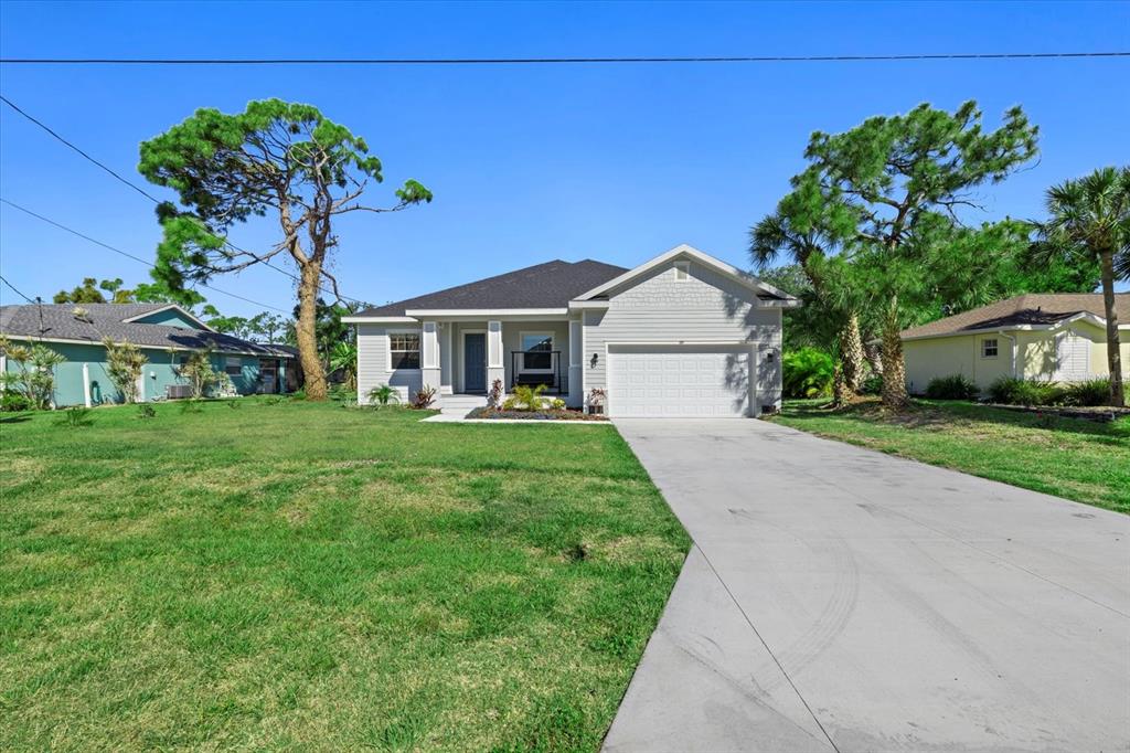 a front view of a house with a garden