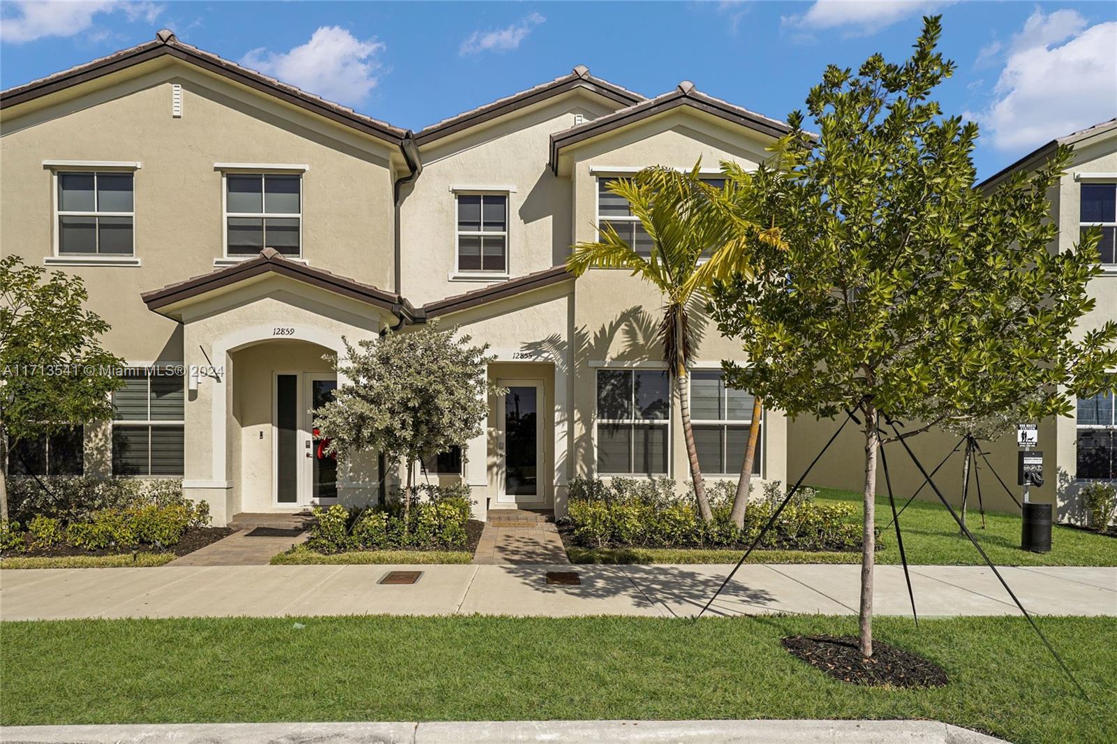 a front view of a house with a yard