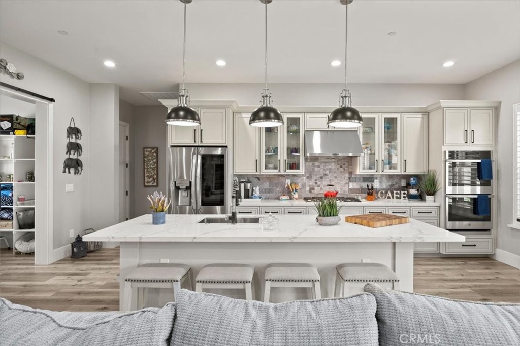 a large kitchen with a table and chairs