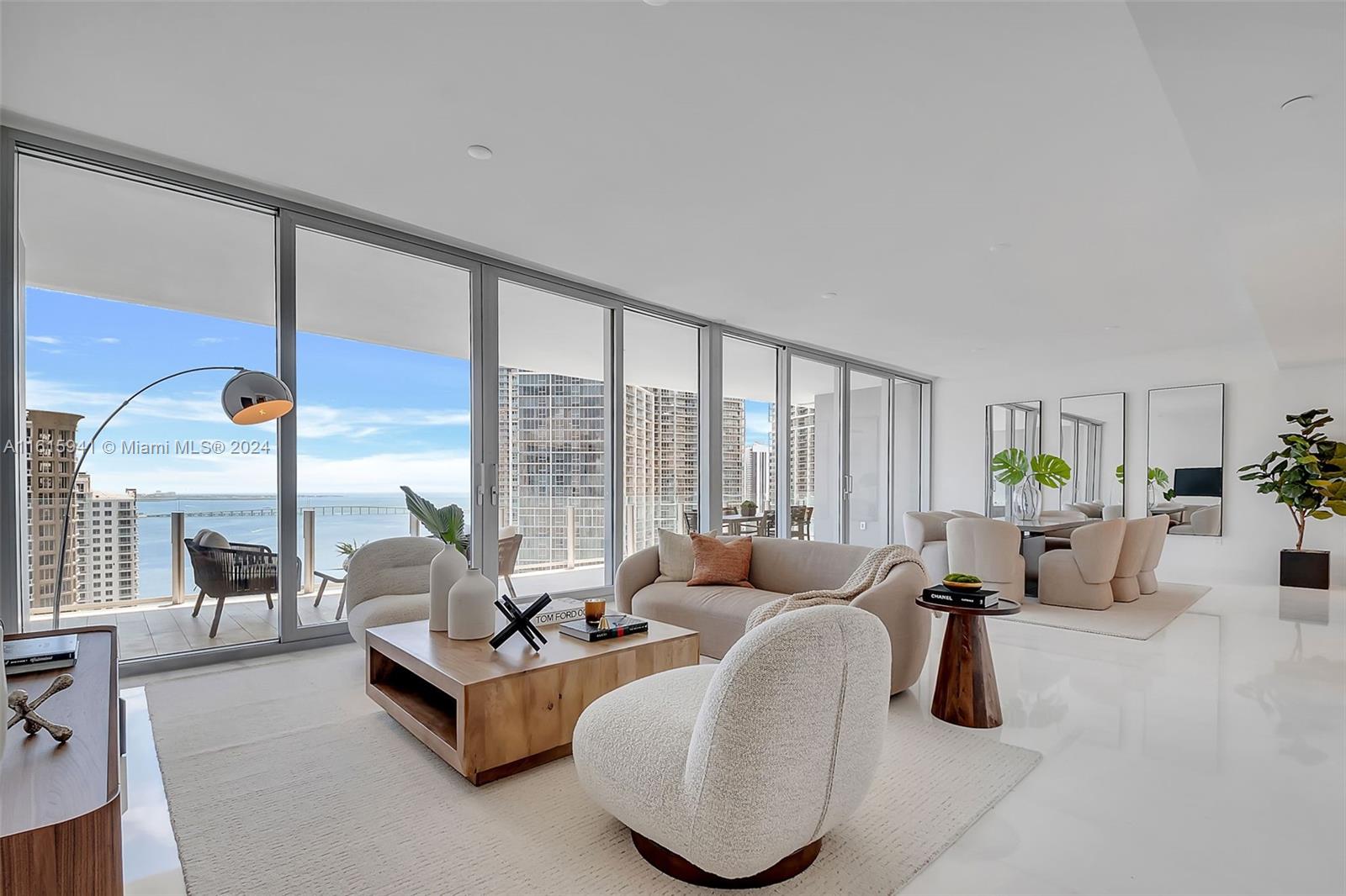 a living room with furniture and large windows