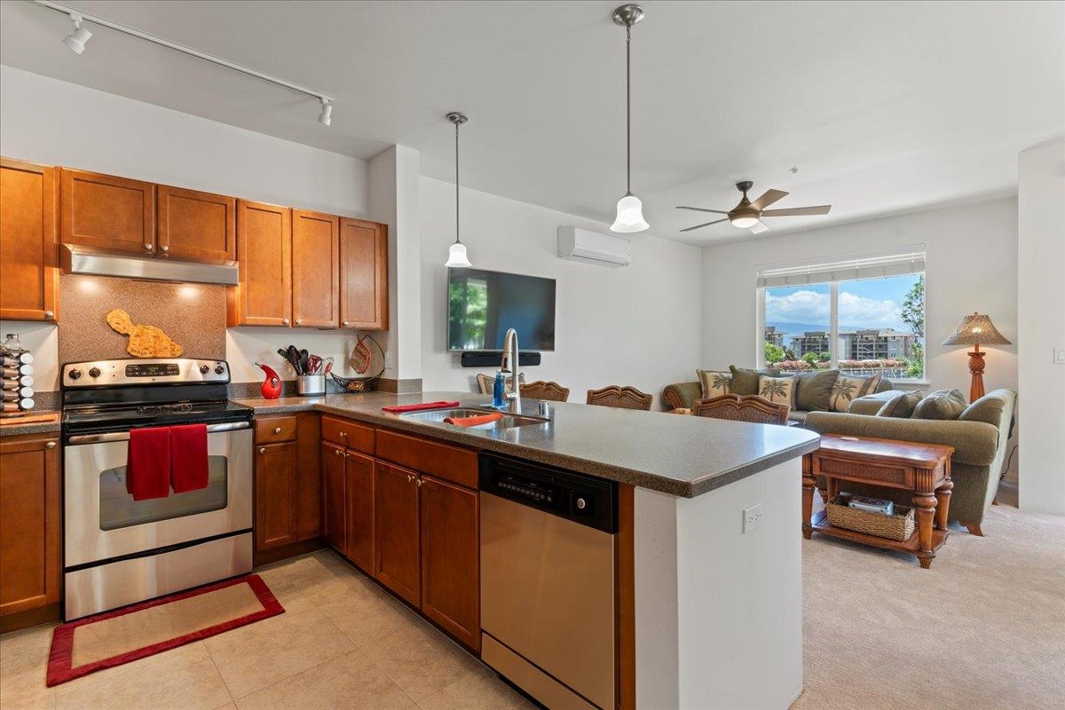 a kitchen with kitchen island granite countertop a sink counter top space and stainless steel appliances