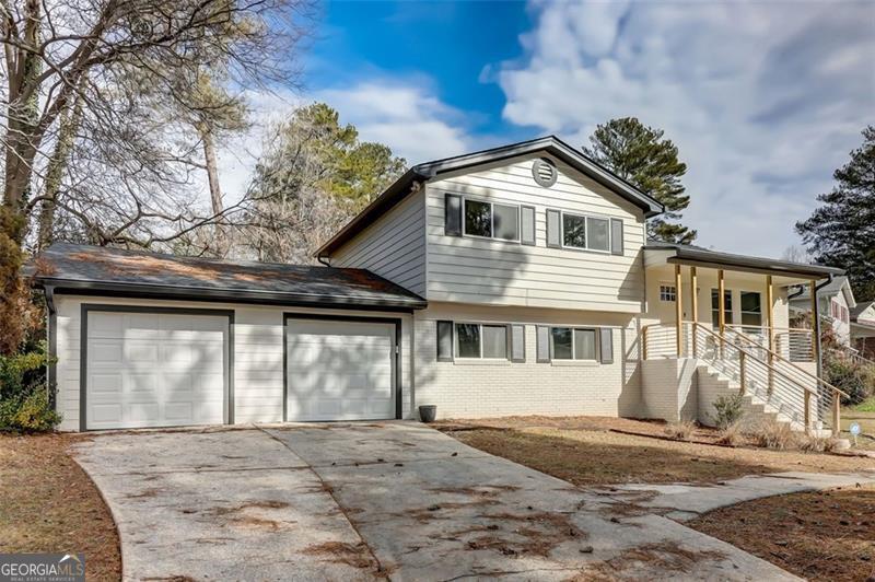 a view of a house with a yard and garage