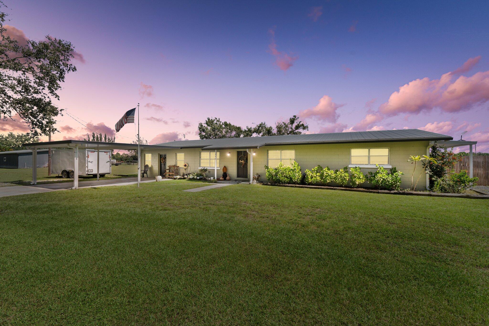 a front view of a house with a garden and a yard