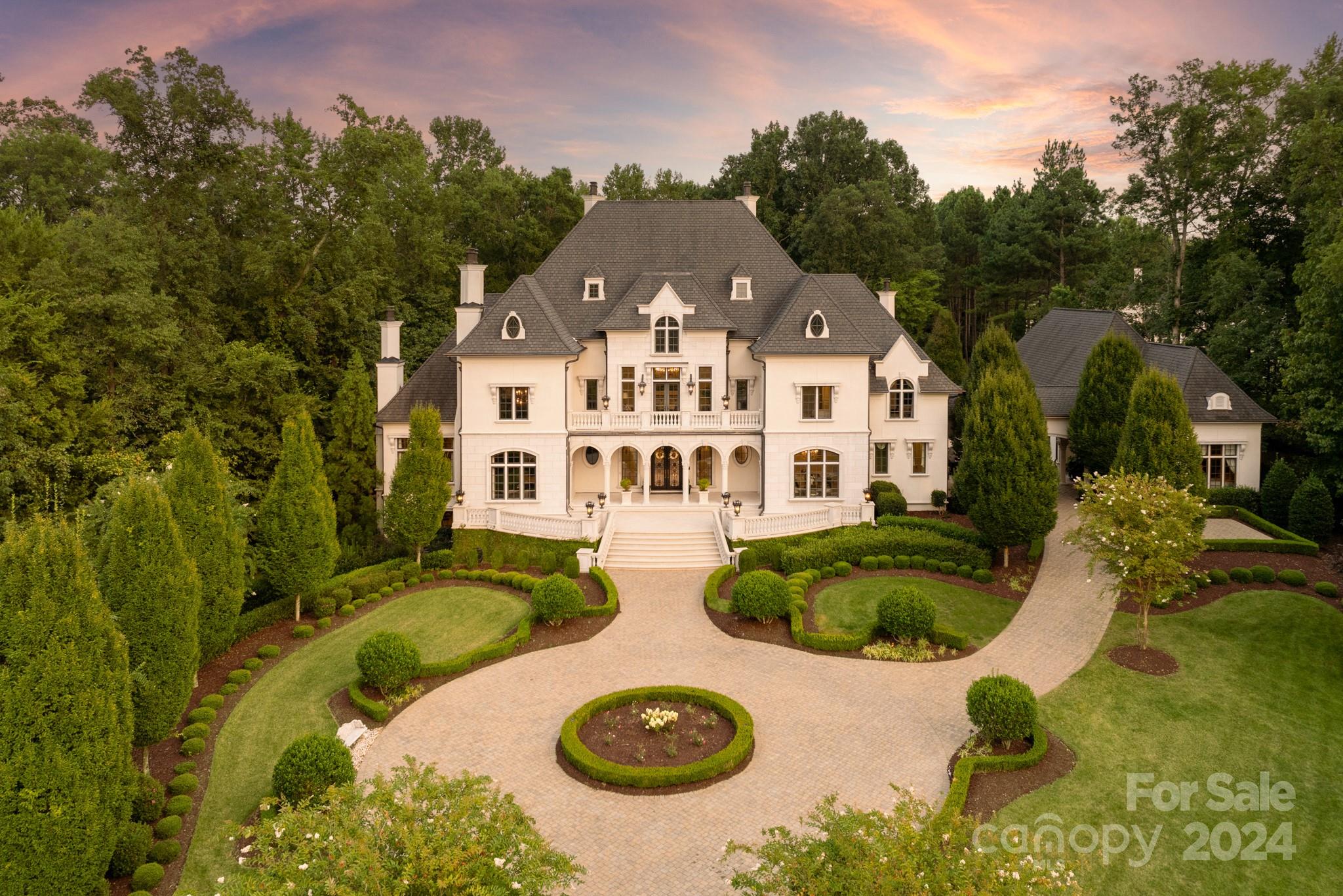 a view of a white house with a swimming pool and outdoor space