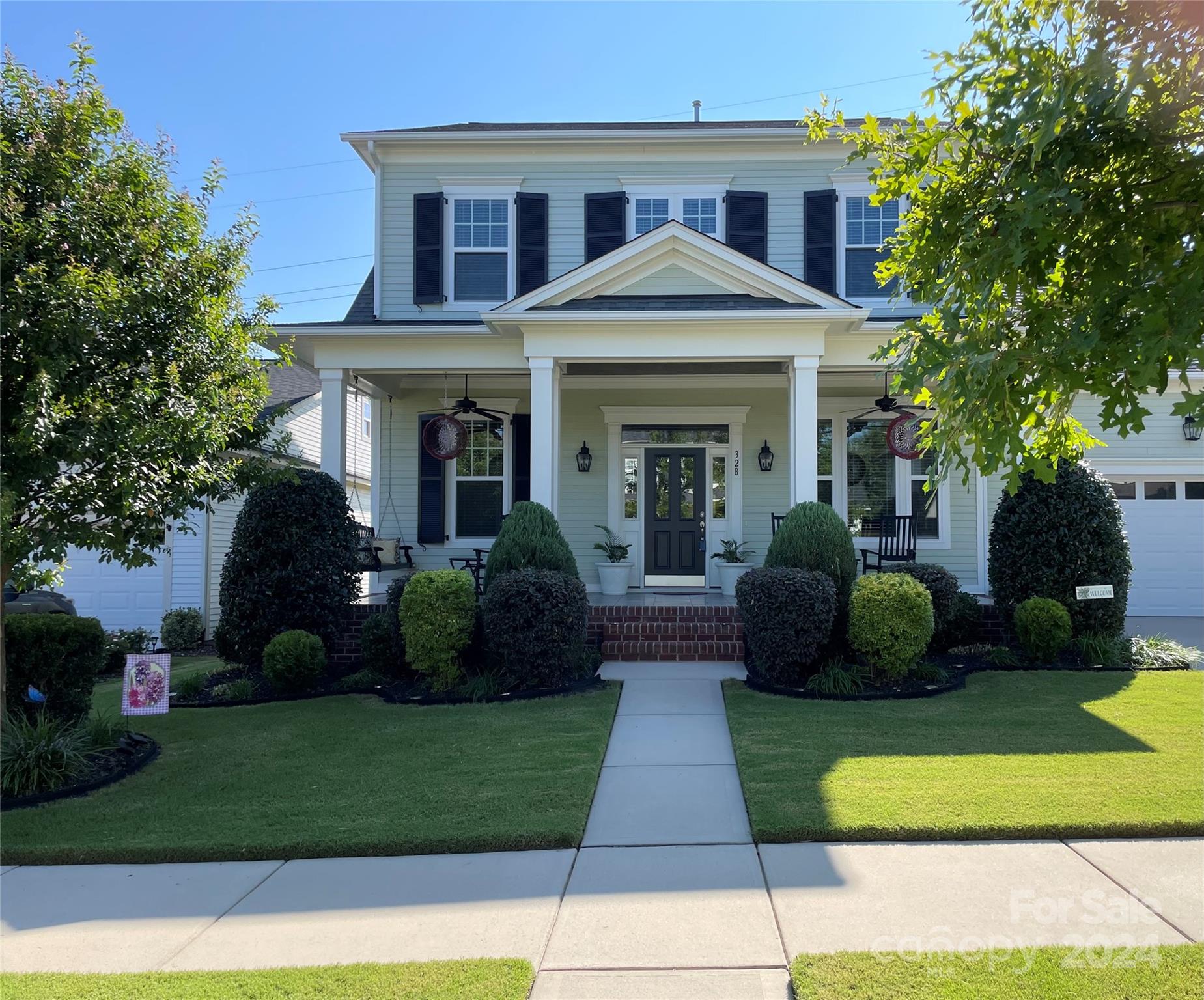 a front view of a house with a garden