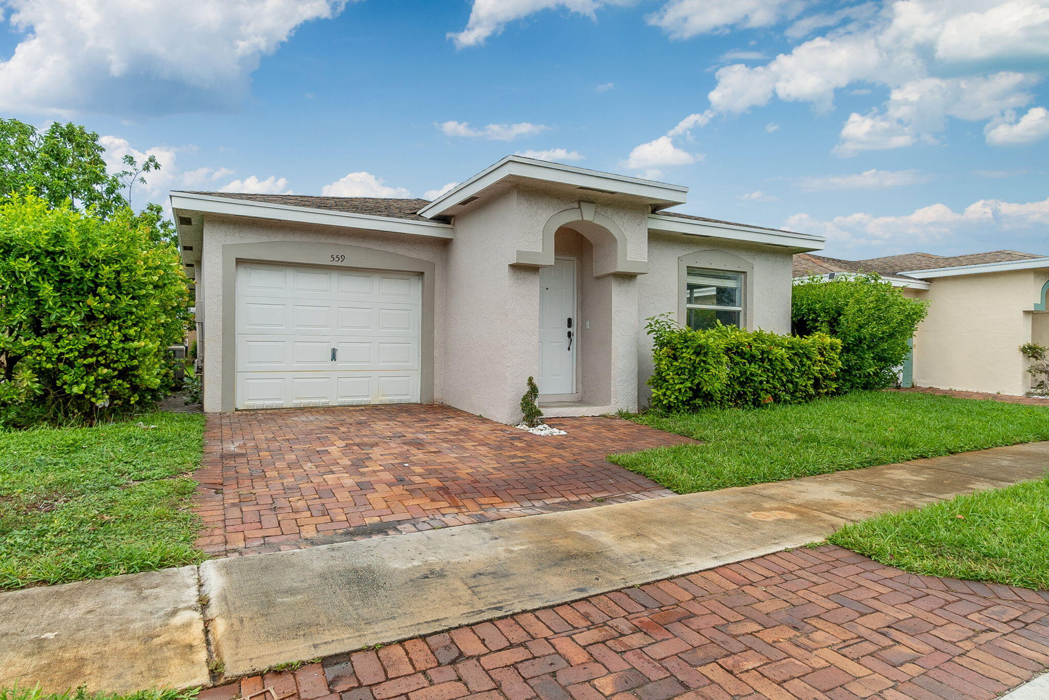 a view of a house with a yard and garage