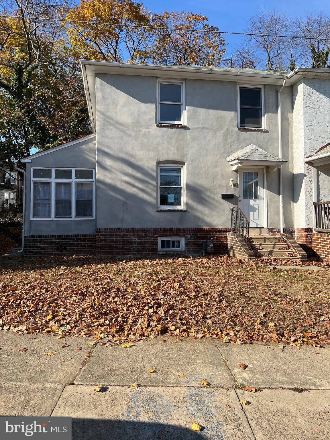 front view of a house with a bench